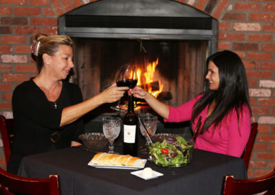 Friends enjoying wine by our fireplace